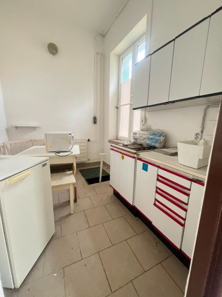 Kitchen area in the production premises with tiles and storage cabinets.