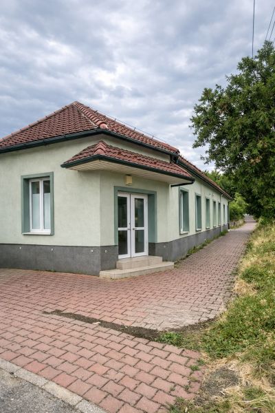 Single-story production facilities in Diakovce with a red tile roof and paved flooring.