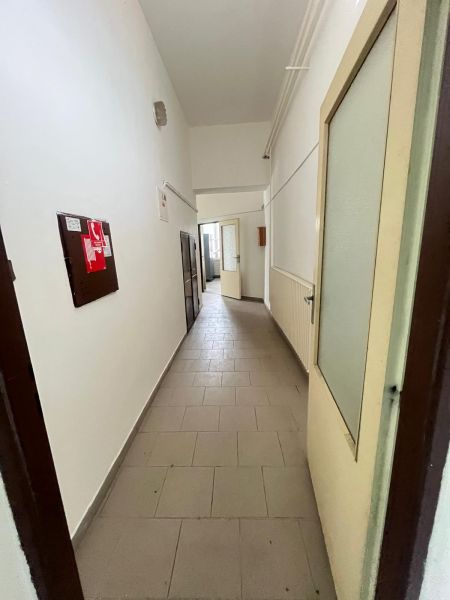 A narrow corridor with white walls and passage doors in the production area.