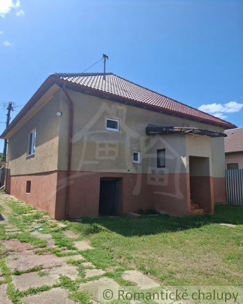 A family house in Ružiná with a gable roof and small windows.