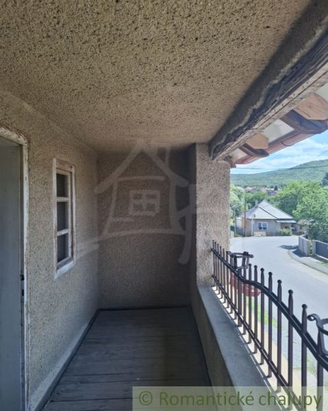 A balcony with a view of the street and surrounding nature in Ružiná, family house.