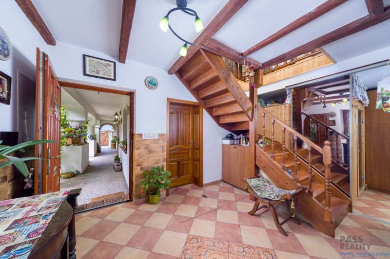 Interior of a family house with wooden stairs and a floor with a wooden decor.