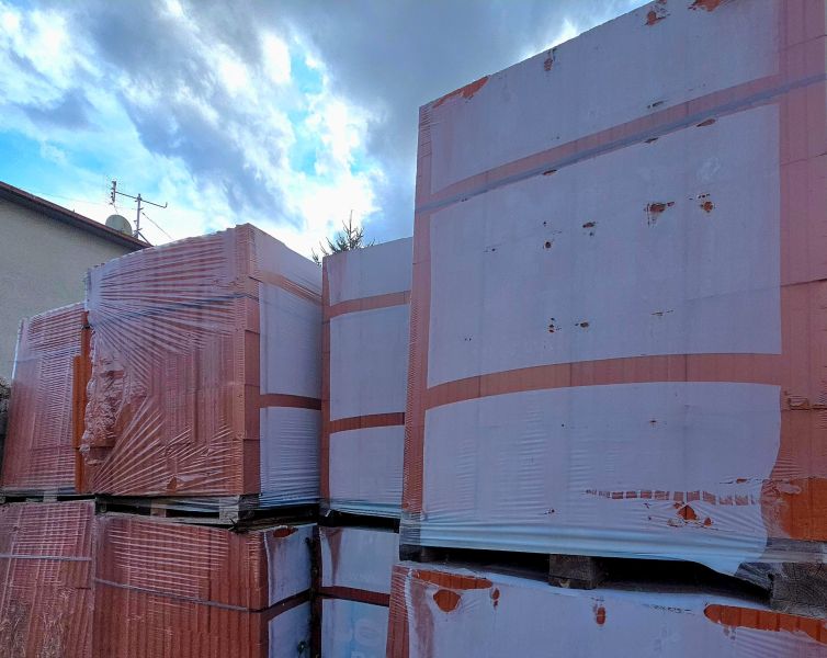 Building material on residential plots in Tešedíkovo near the buildings.
