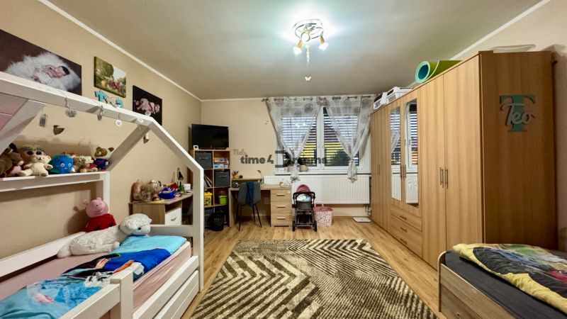 Children's room in a family house with a wooden decor floor and furniture.