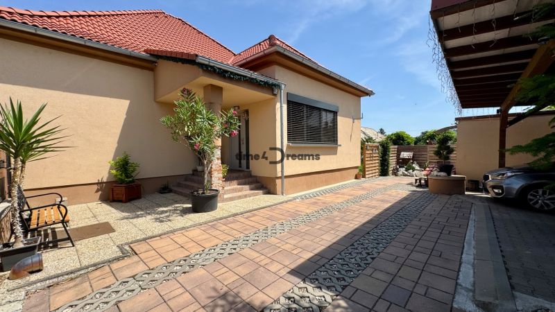 A family house in Čakajovce with a landscaped yard and parking space in front of the entrance.