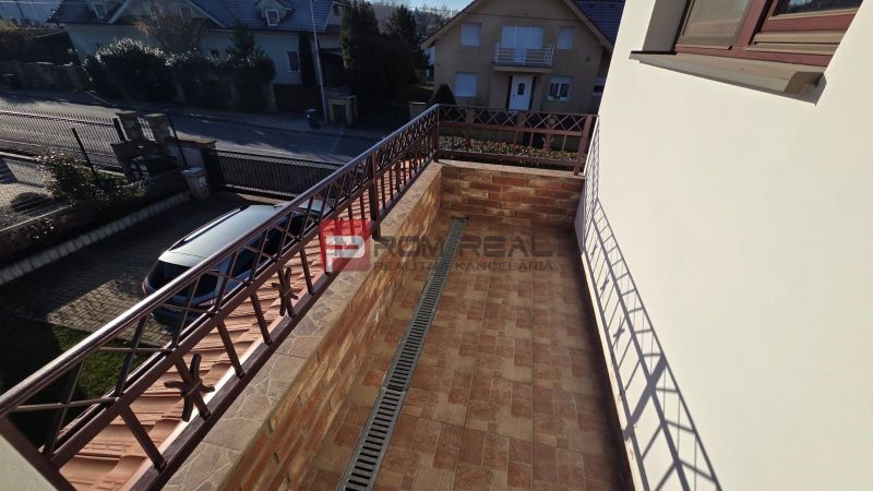 The balcony of a family house on Pri Vápenickom Potoku Street in Bratislava IV with brick cladding.