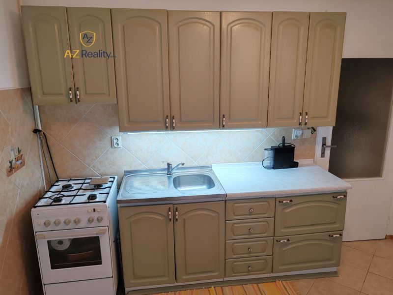 A kitchen in a 4-room apartment with a kitchen unit and a stove.