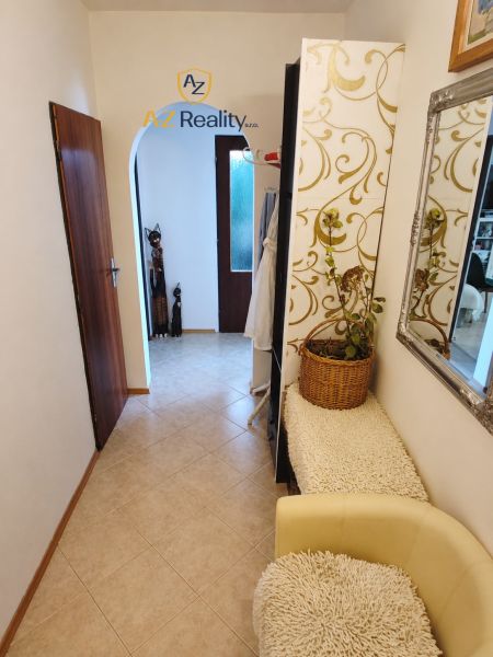 A hallway in a 4-room apartment with arched passages and decorated walls.