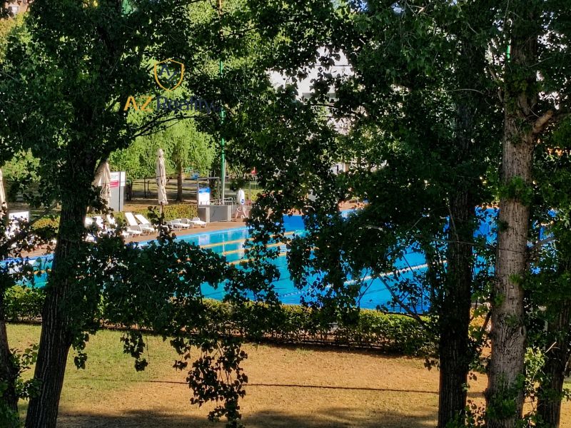 A summer pool surrounded by greenery on Hradná Street in Komárno.