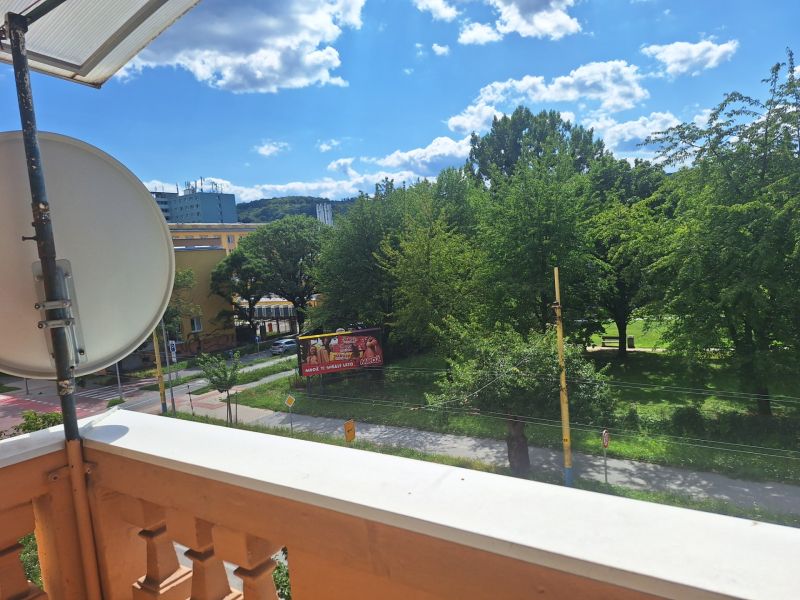 View of greenery and 17. novembra Street in Prešov from a 2-room apartment.