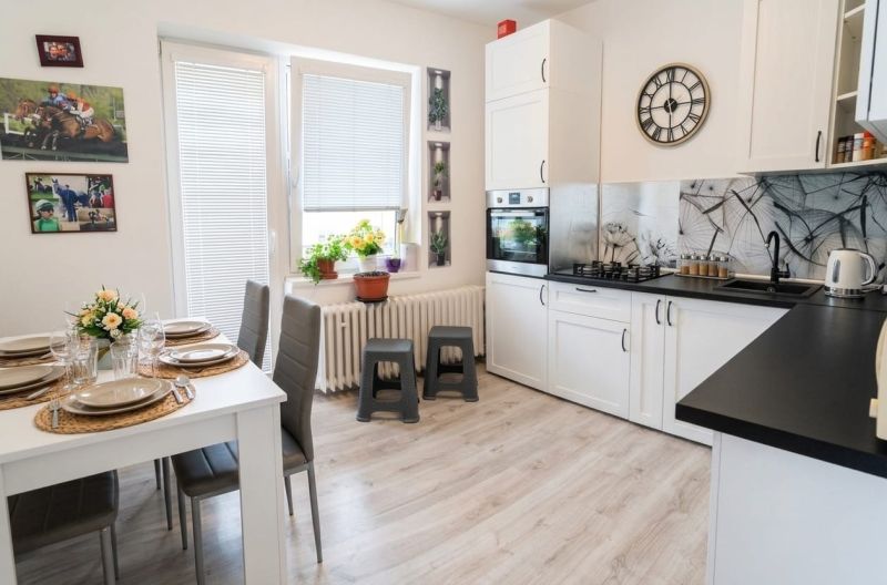 The family house has a bright kitchen with a dining table and decorations.