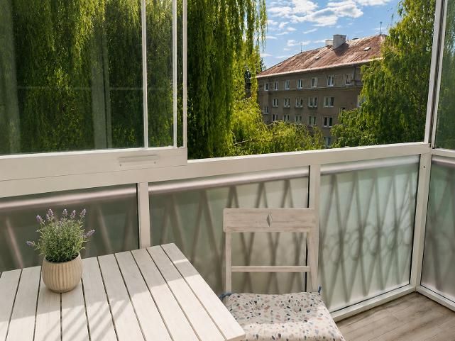 A glazed balcony with a view of greenery in a 2-room apartment on 29. Augusta in Banská Bystrica.