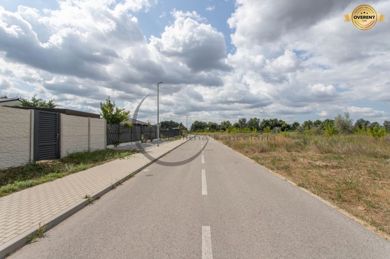 The road on Brezová Street in Zohor, surrounded by residential plots and greenery.