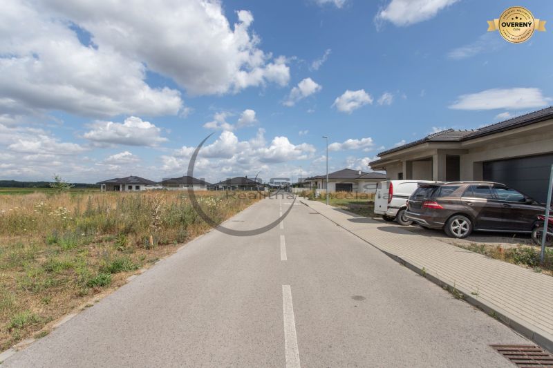The road on Brezová Street in Zohor, surrounded by new buildings and residential plots.