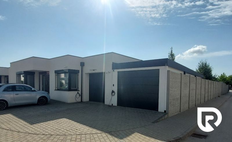 A family house on Rizlingova Street in Trenčín with a built-in garage and a car.