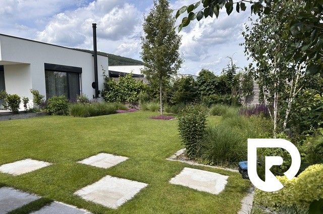A family house on Rizlingova Street in Trenčín with a landscaped garden and lawn.