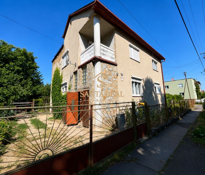 A family house on Mládežnícka Street in Šahy with stone cladding and a garden.