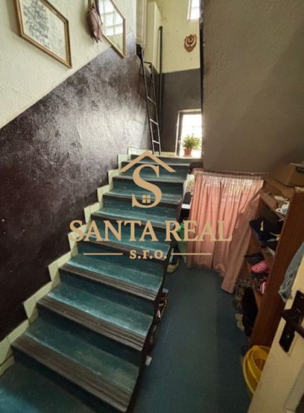 A staircase in a family house with textiles and decorations on the walls.