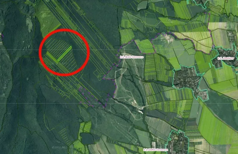 Aerial view of agricultural and forest lands in Veľké Ozorovce with a marked area.