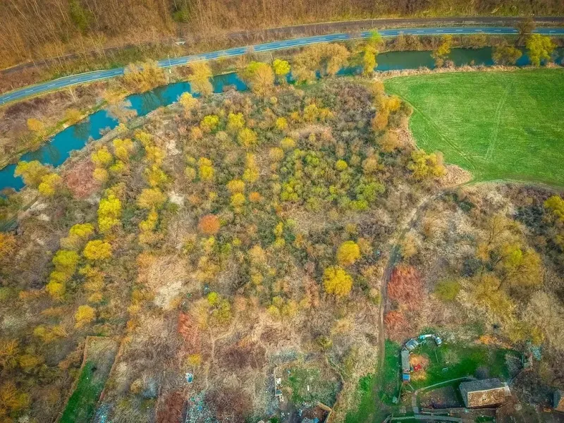 Aerial view of nature by the river in the town of Muľa, Land - residential.