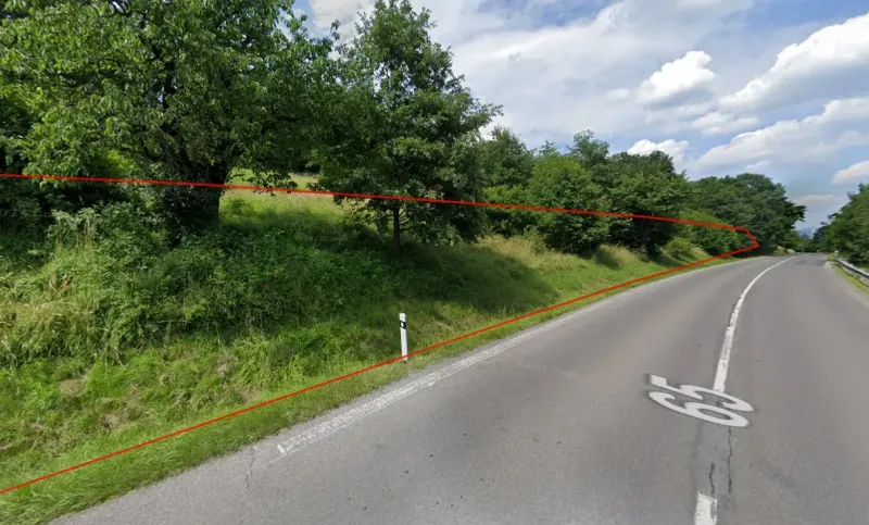 A green slope with a road in Orovnica, part of a unique property.