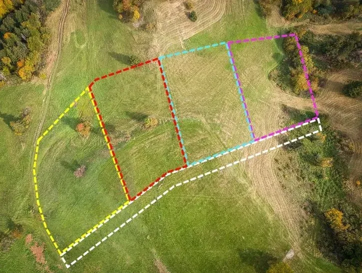 Aerial view of parceled land in Banská Štiavnica, surrounded by greenery, Unique properties.