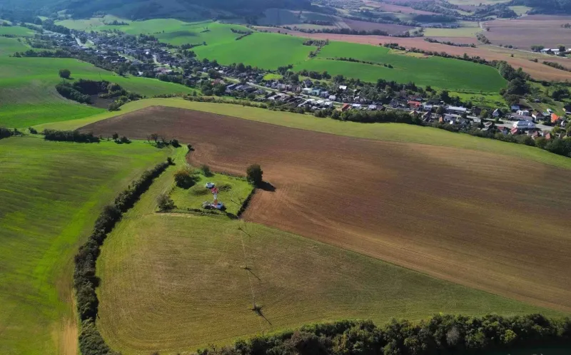 Agricultural and forest lands around the village of Trenčianske Stankovce with extensive fields.