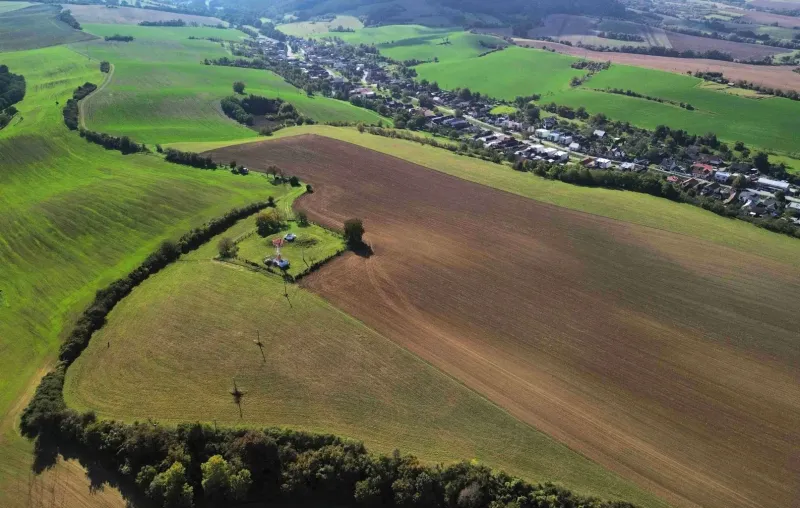 Greenery and arable land surround the village of Trenčianske Stankovce, emphasizing agricultural and forest land.
