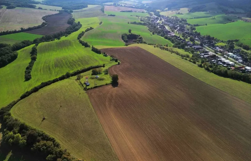 Agricultural and forest land around Trenčianske Stankovce, with an extensive view of the countryside.