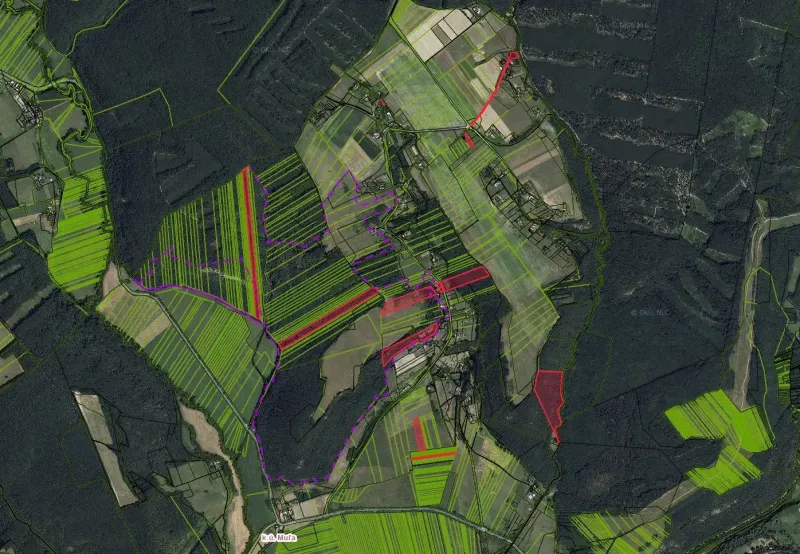 Aerial view of agricultural and forest lands in the village of Muľa, various shades of green.