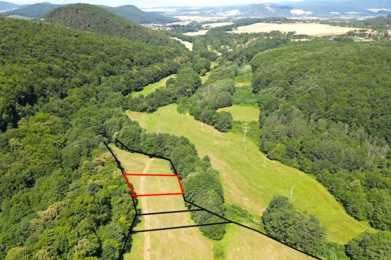 Aerial view of the green Gardens in Horná Ves, surrounded by forests and meadows.