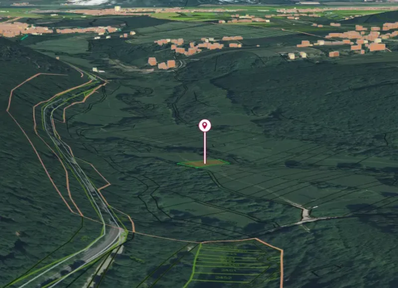 Aerial view of gardens in Horná Ves surrounded by forested and agricultural land.