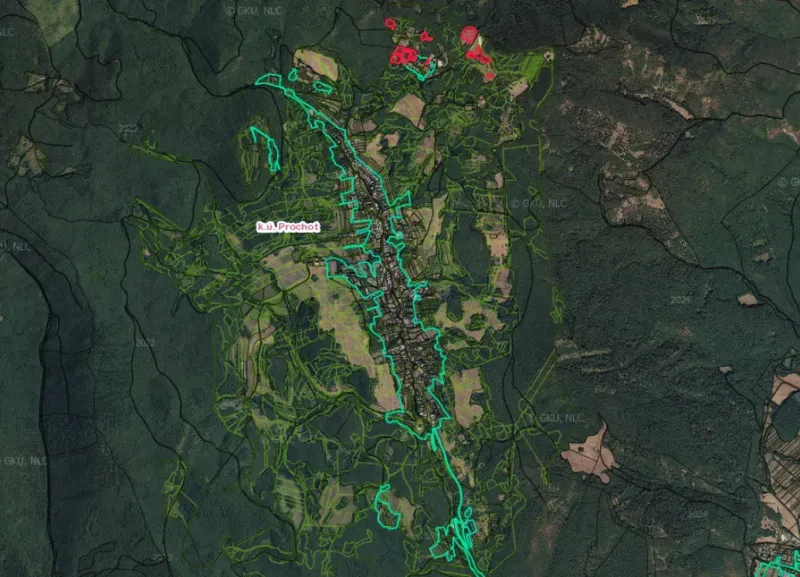 Aerial view of agricultural and forest lands in Prochot surrounded by dense forests.