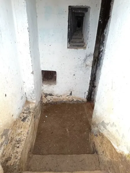 Underground corridor in Special Properties with clear signs of wear and old walls.