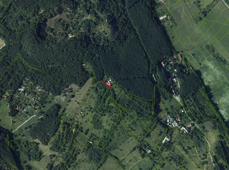 An aerial view of extensive forests and scattered plots around Krupina.