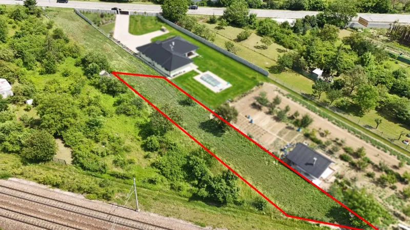 Aerial view of plots - housing in Nové Mesto nad Váhom, marked with a red line.