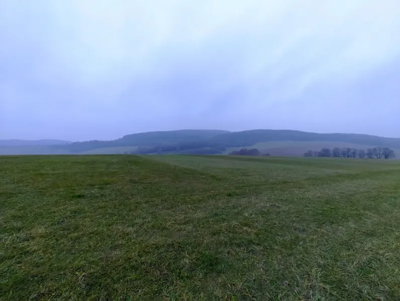 A landscape with green meadows and distant hills around Podkylava, Unusual properties.