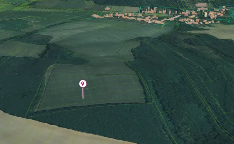 Agricultural and forest lands in Trebušovce, surrounded by fields and wooded areas.