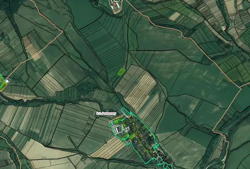 Agricultural and forest lands around Podhorany, with significant parceling and property boundaries.