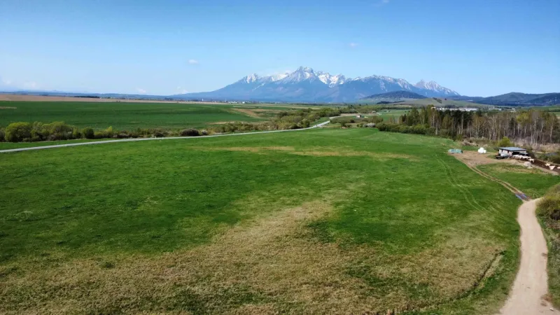 Agricultural and forest land in Podhorany with views of the mountains and green meadows.