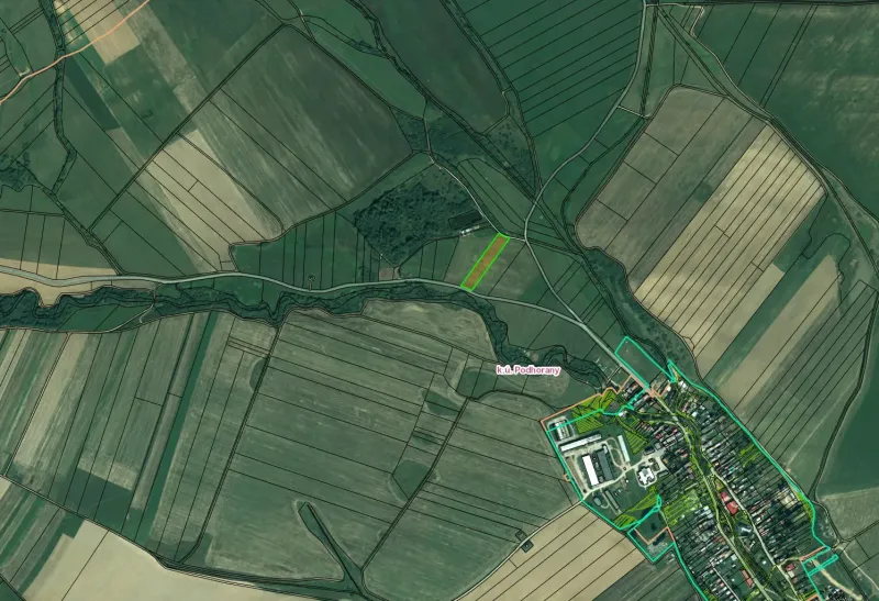 Aerial view of agricultural and forest lands around Podhorany.