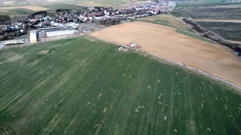 Aerial view of agricultural and forest lands around the village of Podhorany.