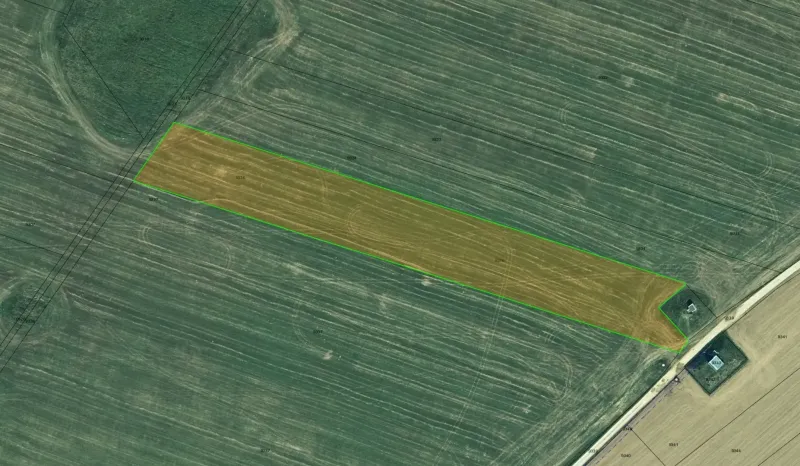 Aerial view of agricultural and forest land in Podhorany with the highlighted parcel.