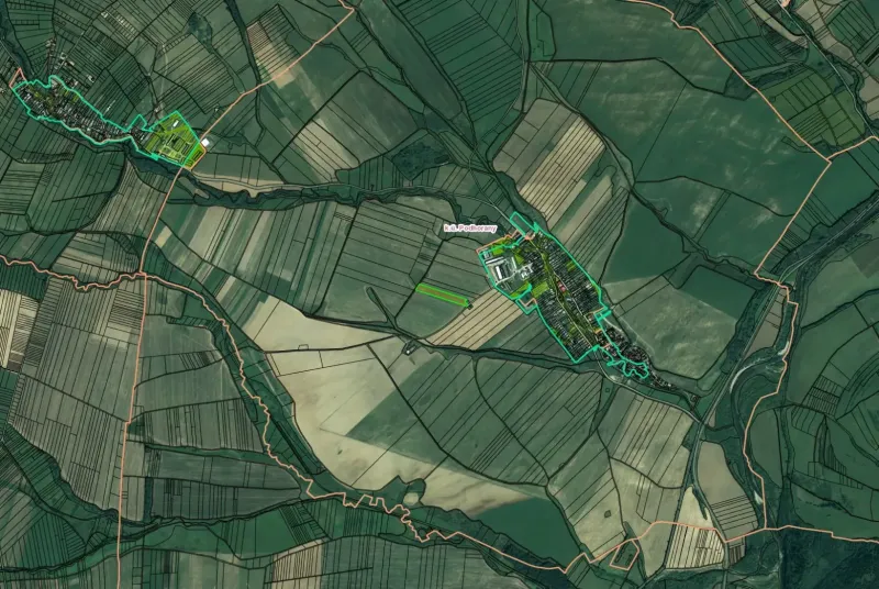 Aerial view of agricultural and forest lands around Podhorany, with visible parceling.
