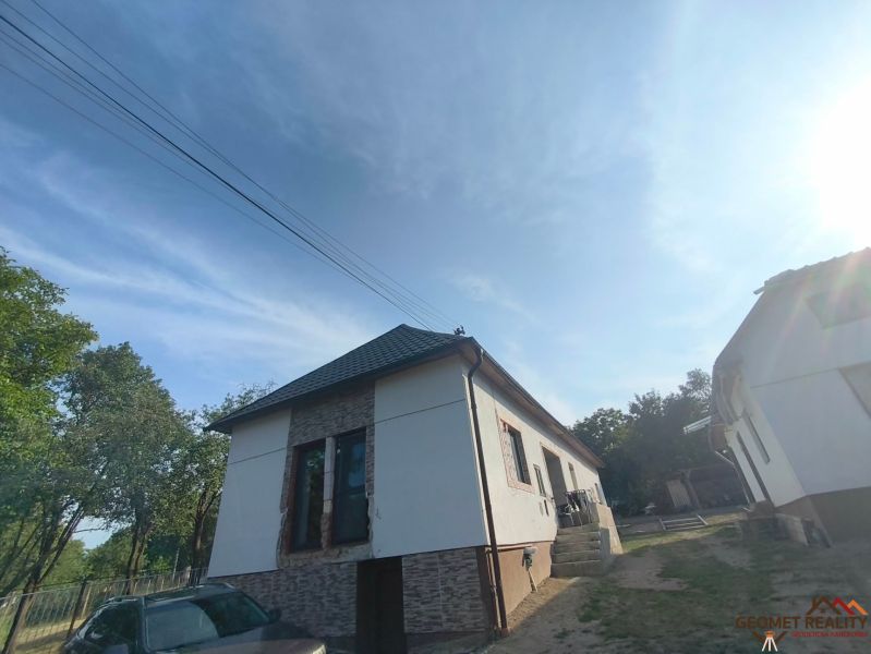 A family house in Dobroč with a roof, a car, and a fence on Dobroč street.
