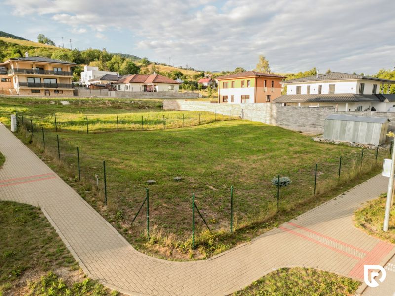 Plots - housing in the Kasárne District in Brezno with sidewalks and family houses in the background.