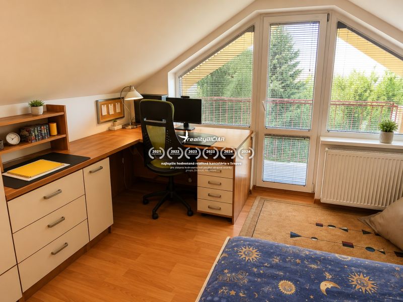 A workspace in the attic of a family house with a wooden decor floor.