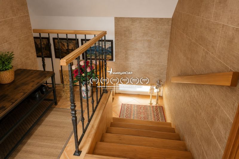 Interior of a family house with a wooden staircase and decorative elements.