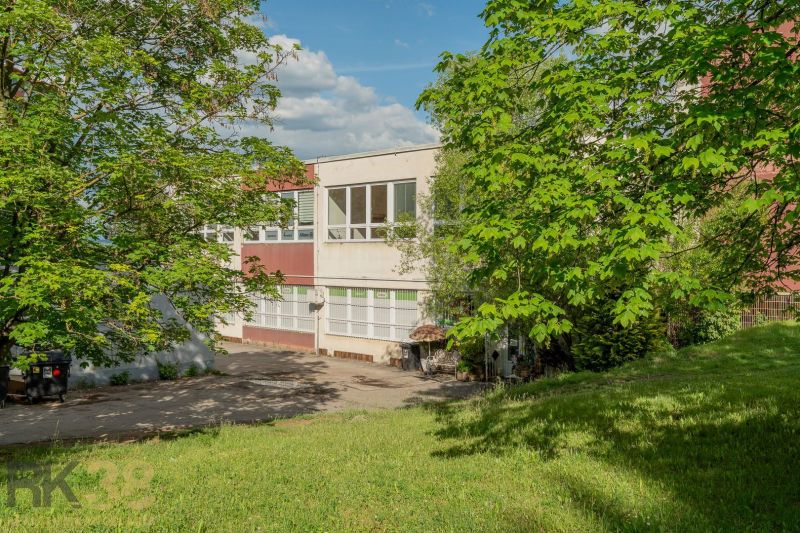 A building in Banská Bystrica surrounded by greenery and lawn.