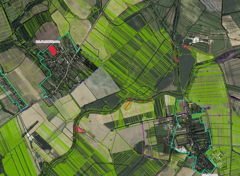 An aerial view of various agricultural fields and structures around Rapovce.